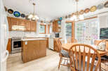 This charming kitchen boasts beautiful oak cabinetry and a spacious island, perfect for meal preparation and casual dining.