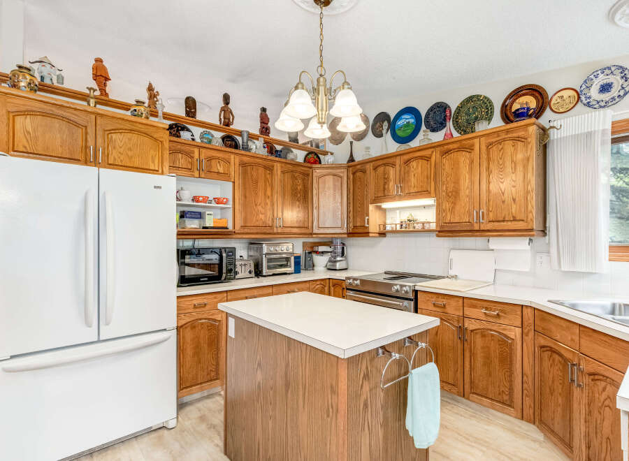 This charming kitchen boasts beautiful oak cabinetry, offering ample storage and a warm, inviting aesthetic.
