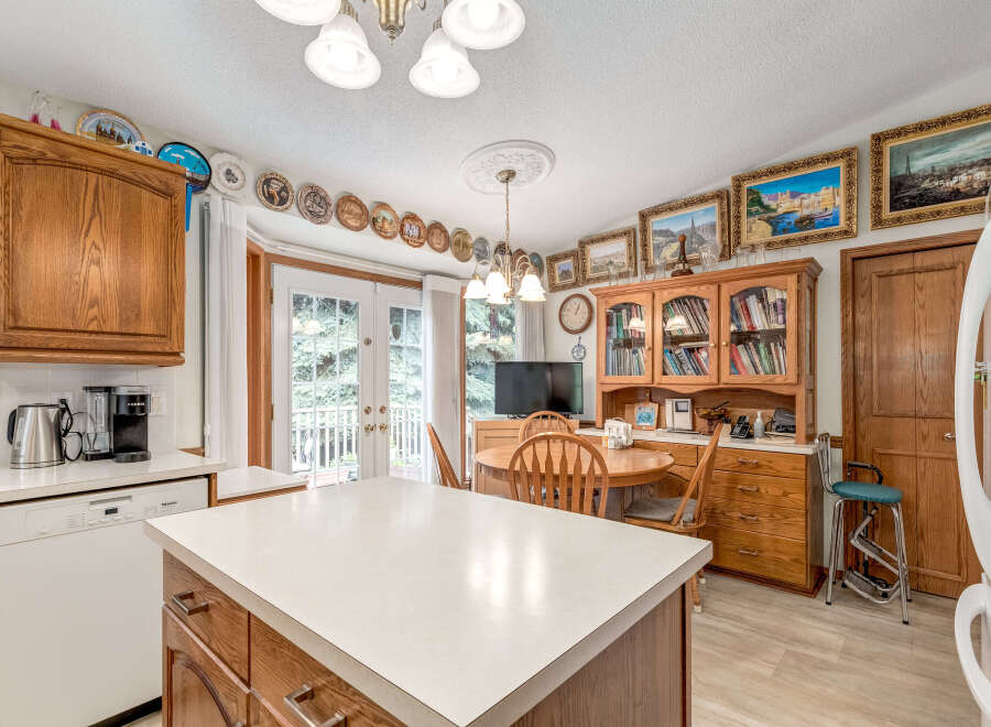This charming kitchen boasts ample wooden cabinetry, providing abundant storage space.