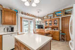 This charming kitchen boasts ample wooden cabinetry, providing abundant storage space.