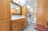 This bathroom features a spacious vanity with ample storage and a large ornate mirror.