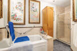 This accessible bathroom features a walk-in bathtub with a built-in lift and grab bars for enhanced safety and convenience.