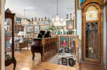 Step into a grand foyer featuring a stunning grandfather clock and a beautifully ornate staircase.