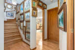 Step into a home adorned with a stunning collection of framed artwork, creating a gallery-like ambiance throughout the entryway and staircase.