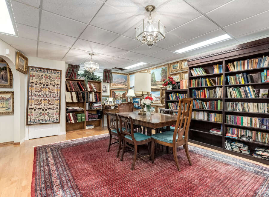 This inviting room features a large wooden dining table with upholstered chairs, perfect for family gatherings or intimate dinners.