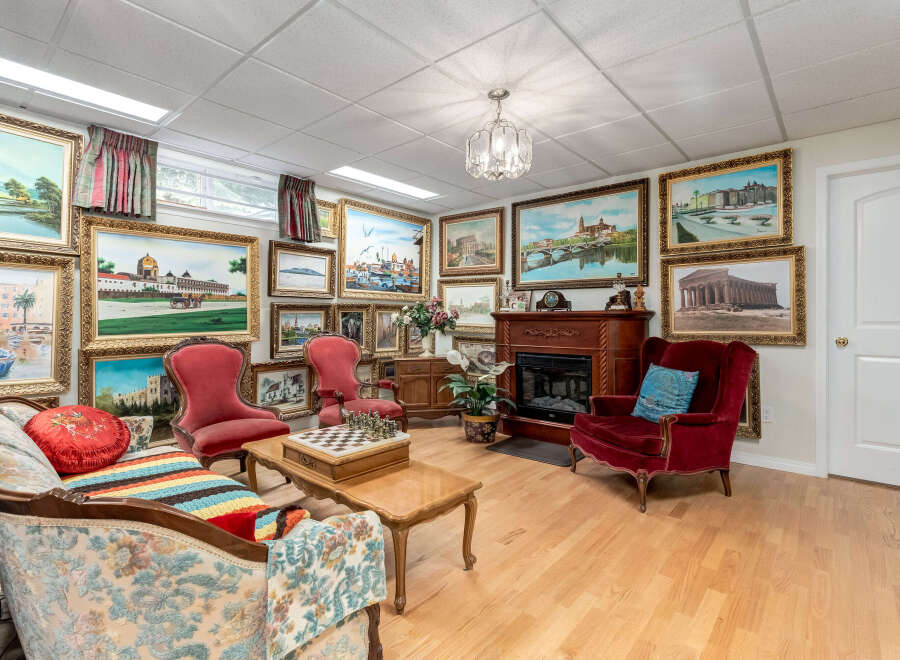 Step into this uniquely decorated living room, featuring an impressive collection of framed artwork adorning the walls, creating a gallery-like atmosphere.