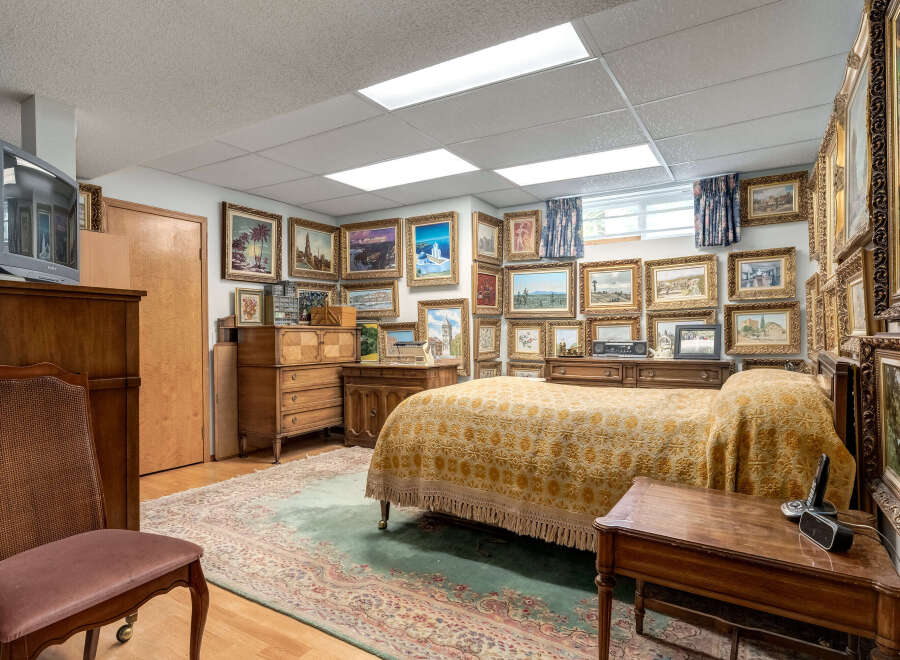 This charming bedroom features a cozy bed adorned with a decorative yellow quilt, perfect for relaxation.