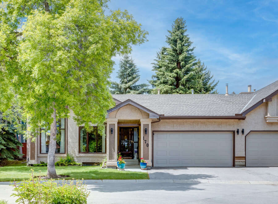 This charming home features a welcoming entrance with decorative planters and a prominent house number '170'.
