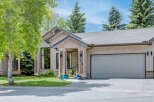 Charming single-family home featuring a stucco exterior and a welcoming covered entryway with decorative columns.