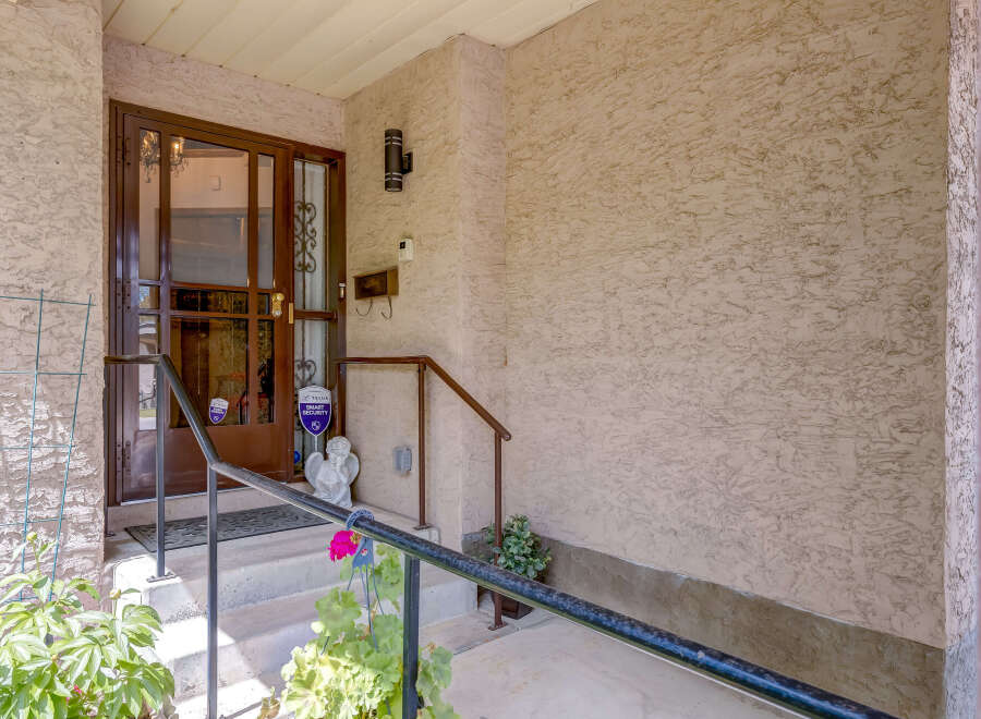 Welcome guests to this charming home with a welcoming covered porch, perfect for enjoying your morning coffee.