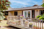 Enjoy outdoor living on this charming deck, perfect for relaxing or entertaining.