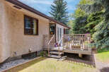 Enjoy outdoor living on this charming deck, perfect for entertaining or relaxing amidst lush greenery.