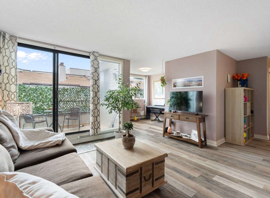 Bright and airy living room featuring a comfortable sectional sofa, a stylish coffee table, and a large TV for entertainment.