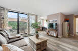 Bright and airy living room featuring a comfortable sectional sofa, a stylish coffee table, and a large TV for entertainment.