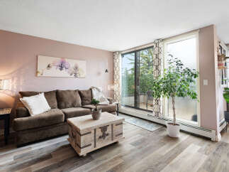 Experience comfortable living in this inviting living room, featuring a plush brown sofa perfect for relaxation.