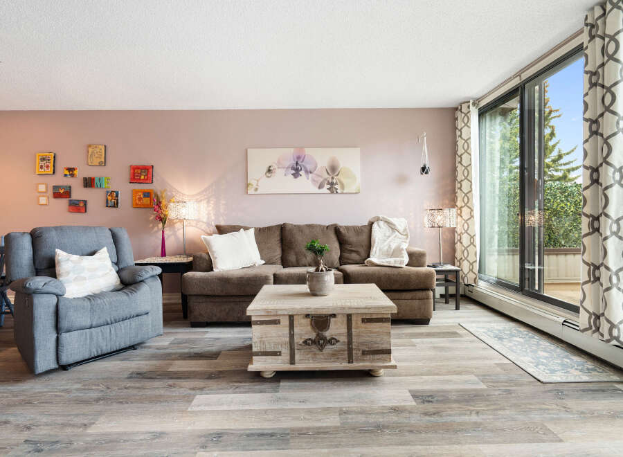 Step into this inviting living room, featuring a plush grey recliner and a comfortable brown sofa perfect for relaxation.