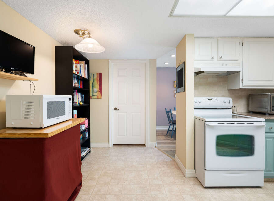 Discover this charming kitchen featuring a white oven and microwave, perfect for home chefs.