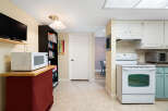 Discover this charming kitchen featuring a white oven and microwave, perfect for home chefs.