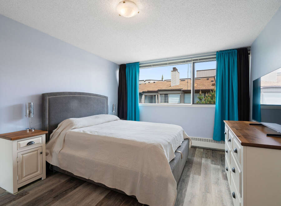 This bedroom features a comfortable king-sized bed with a plush headboard, perfect for relaxation.