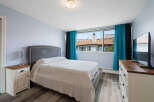 This bedroom features a comfortable king-sized bed with a plush headboard, perfect for relaxation.