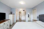 Discover comfort and convenience in this inviting bedroom, featuring a spacious layout and a private ensuite bathroom accessible through a charming doorway.