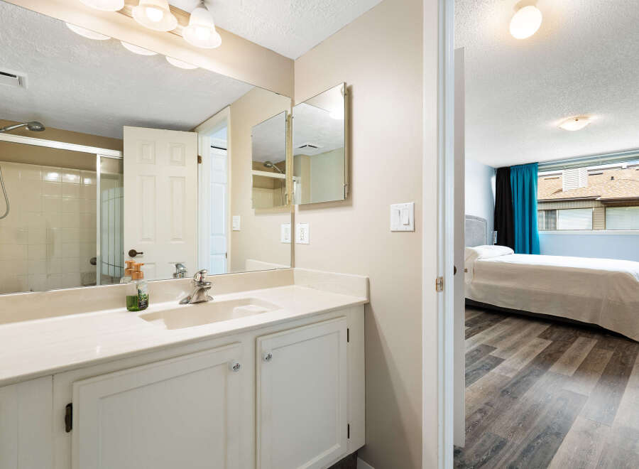 Discover comfort and convenience in this well-appointed bathroom featuring a spacious vanity with ample storage and a sleek shower stall.