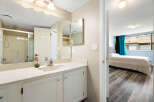 Discover comfort and convenience in this well-appointed bathroom featuring a spacious vanity with ample storage and a sleek shower stall.