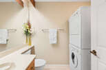 This bathroom features a stacked washer and dryer, perfect for maximizing space in a compact area.