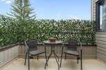 Enjoy your morning coffee or evening relaxation on this charming balcony, complete with a bistro set and privacy fencing.