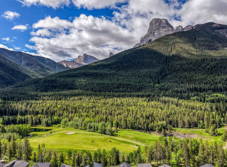 Experience luxury living nestled amidst breathtaking mountain scenery and a pristine golf course.