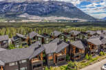 Experience modern mountain living in this stunning multi-unit property, featuring contemporary architecture with natural wood accents and dark siding.