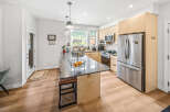 Experience modern living in this stunning kitchen featuring sleek stainless steel appliances, including a spacious refrigerator and microwave.