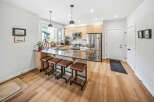 Experience modern living in this stunning kitchen featuring sleek cabinetry, a spacious island with bar seating, and top-of-the-line stainless steel appliances.