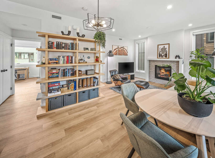 Experience modern living in this beautifully appointed open-concept space, featuring a cozy fireplace and a stylish entertainment area.