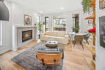 Experience modern living in this bright and airy living room, featuring a cozy fireplace and comfortable seating.