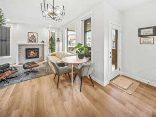 Experience modern living in this stylish living room featuring a cozy fireplace and a comfortable seating area.