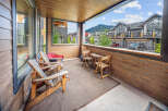 Enjoy the stunning mountain views from this covered balcony, perfect for relaxing evenings.
