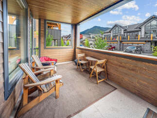 Enjoy the stunning mountain views from this covered balcony, perfect for relaxing evenings.