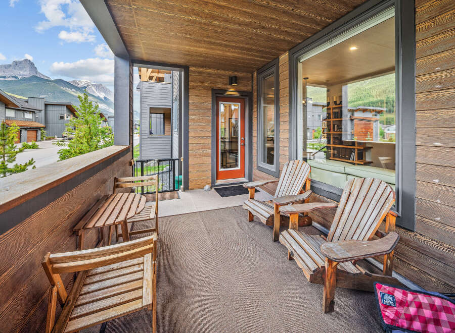 Enjoy breathtaking mountain views from this spacious covered balcony, perfect for outdoor dining or relaxing.