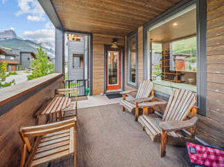 Enjoy breathtaking mountain views from this spacious covered balcony, perfect for outdoor dining or relaxing.