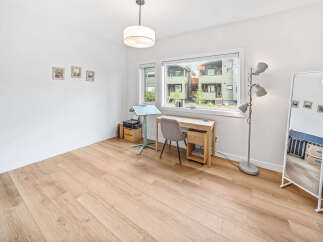 Bright and airy home office space featuring a modern desk and chair setup by a large window.