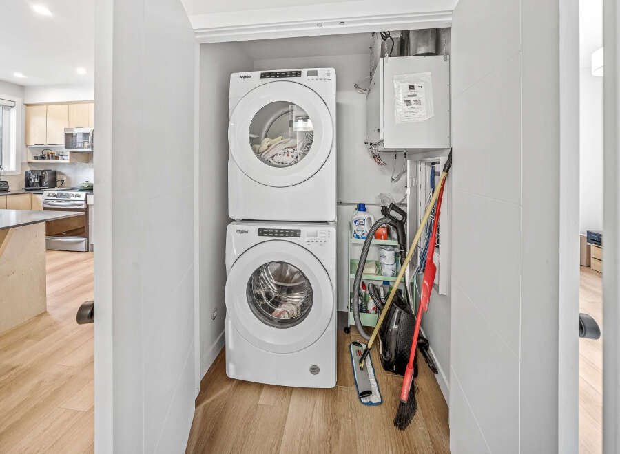 Discover a modern laundry space featuring a stacked Whirlpool washer and dryer, perfect for maximizing efficiency in a compact area.