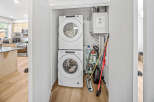 Discover a modern laundry space featuring a stacked Whirlpool washer and dryer, perfect for maximizing efficiency in a compact area.