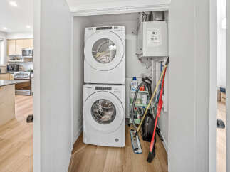 Discover a modern laundry space featuring a stacked Whirlpool washer and dryer, perfect for maximizing efficiency in a compact area.