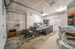 Discover ample storage and organization potential in this spacious garage, perfect for your vehicles and recreational gear.