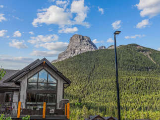 Experience breathtaking mountain views from this stunning property, featuring a modern home with expansive windows that capture the majestic scenery.