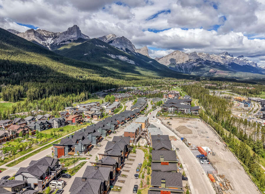 Experience modern mountain living in this stunning new development, nestled against a backdrop of majestic peaks and lush evergreen forests.