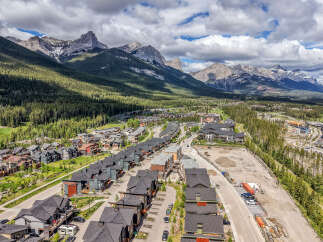 Experience modern mountain living in this stunning new development, nestled against a backdrop of majestic peaks and lush evergreen forests.