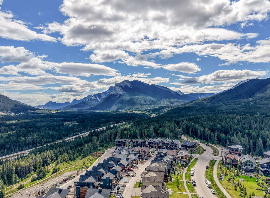 Discover luxury mountain living in this stunning new development, nestled amidst a dense evergreen forest with breathtaking panoramic views of majestic mountains.