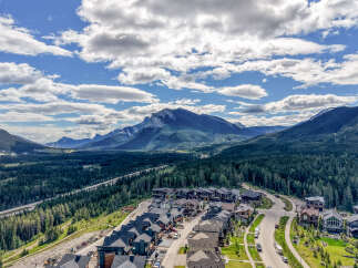 Discover luxury mountain living in this stunning new development, nestled amidst a dense evergreen forest with breathtaking panoramic views of majestic mountains.